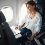 woman sitting in window seat on an airplane