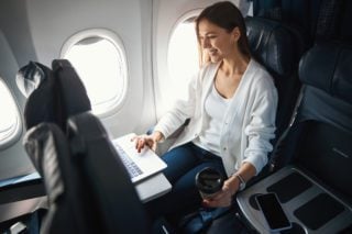 woman sitting in window seat on an airplane