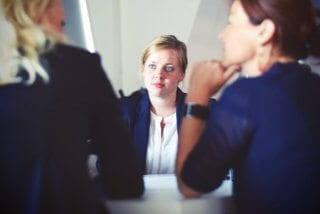 How Expats choose an accountant: Image of three businesswomen sitting at a table.