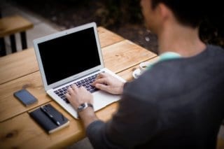 A digital nomad working on a computer outside