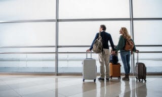 A couple at the airport moving abroad from the U.S.