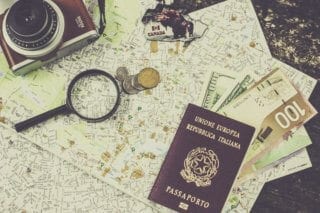 Schengen Visa: Picture of Italian passport and assorted currency 