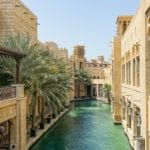 Aerial view of a pool in Dubai surrounding by a courtyard made of light bricks