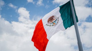 mexican flag against blue sky