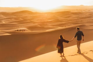 couple walking in dubai in dessert