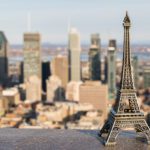 An Eiffel tower miniature against the Montreal skyline, symbolizing French expats