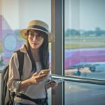 woman traveling on a digital nomad visa at the airport.