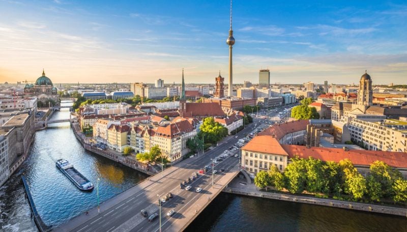 Aerial view of Berlin skyline with famous TV tower and Spree river in beautiful evening light at sunset, Germany.