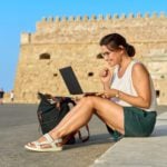 united states expat in europe working on laptop