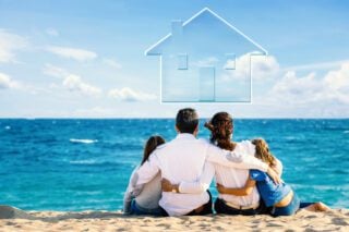 Family on a beach dreaming of purchasing a home overseas