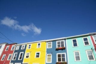 A low angled shot of a row of colorful houses in St. John's, Newfoundland, one of the best places to live in Canada