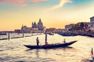 Gondola ride in Venice, Italy at sunset.