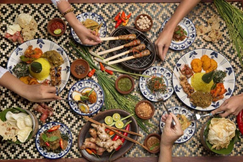 an aerial shot of friends enjoying Indonesian food
