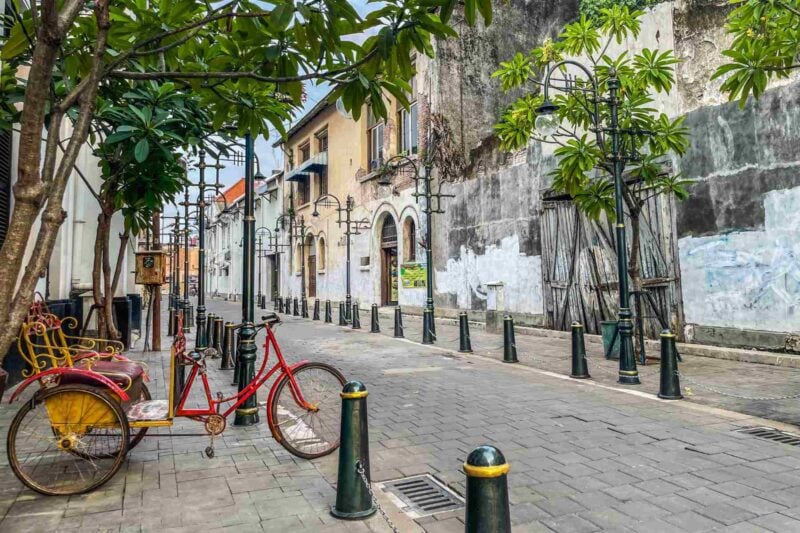 a red bike parked on an empty street in Kota Lama, Semarang
