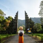 a woman standing in front of a Bali temple having moved to the country after researching the cost of living in Indonesia