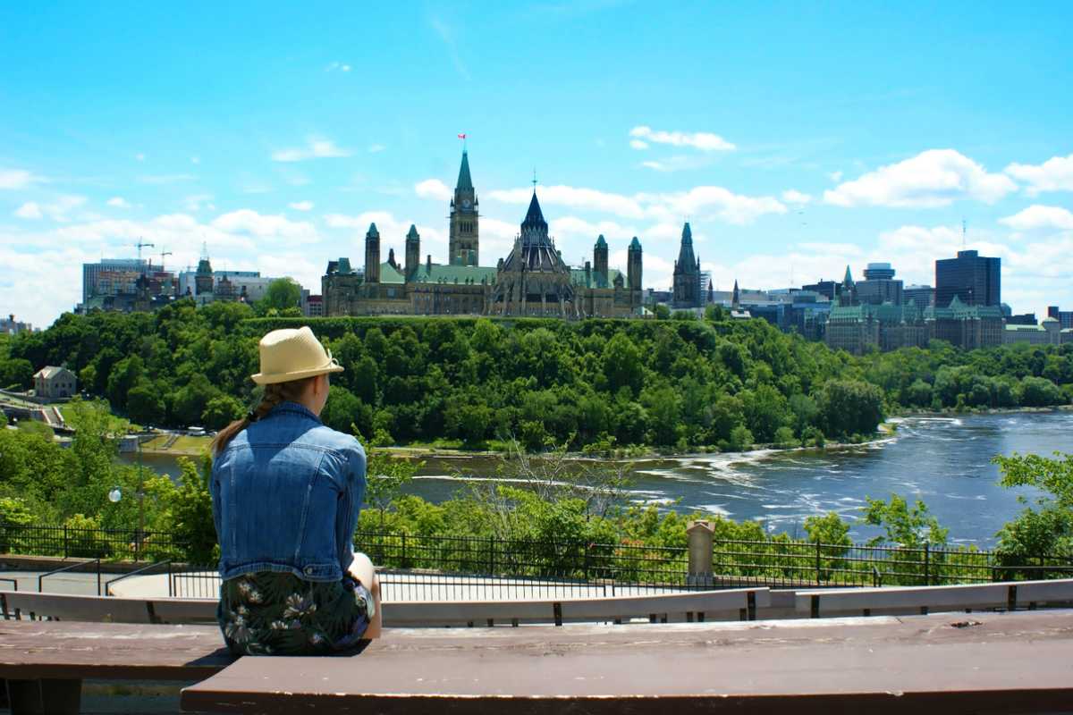 A woman overlooking a city in Canada, one of the safest places to live in the world