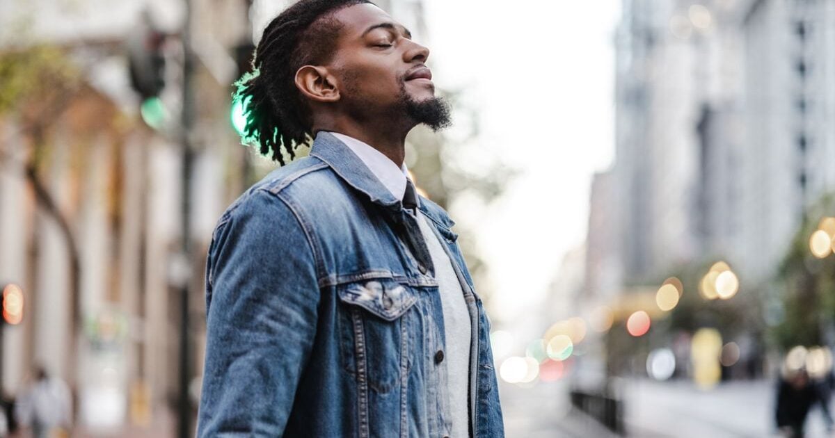 a man taking time to relax and breath on a city street, indicating the need to care for your mental health
