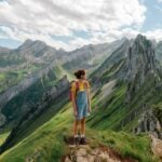 A woman hiking through the Swiss Alps, showcasing Switzerland as one of the best countries for solo travel for women