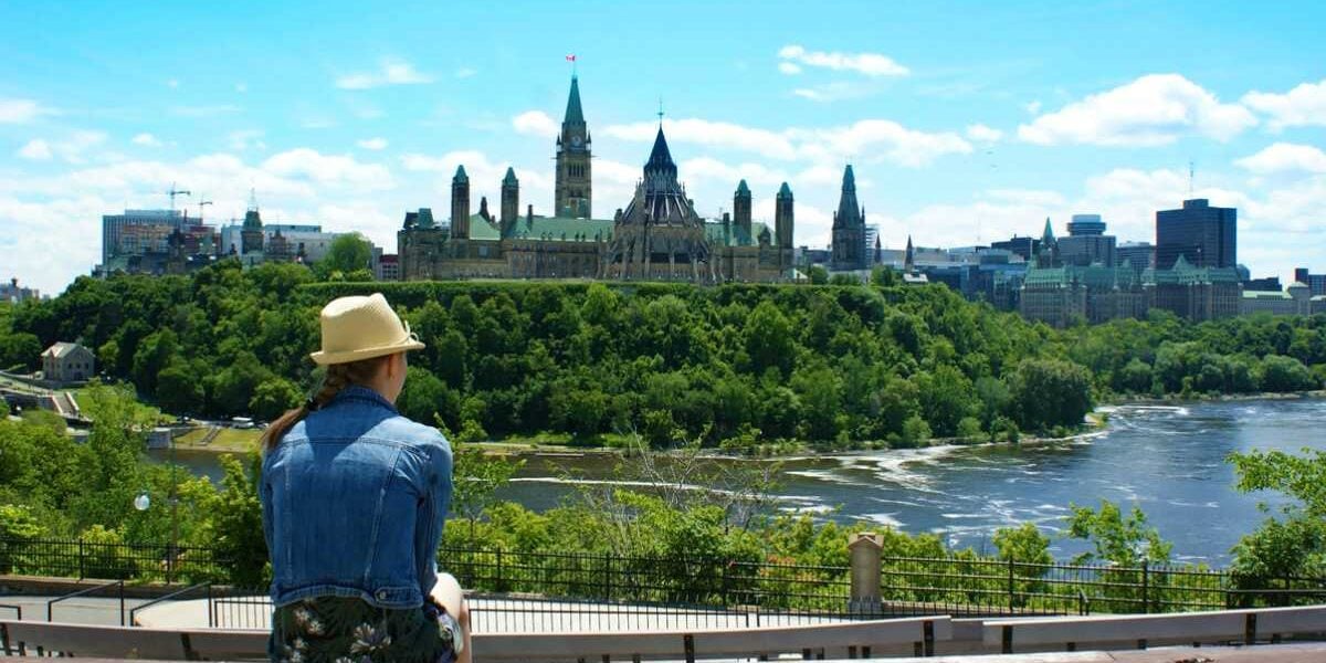 best-place-to-live-canada A woman overlooking a city in Canada, one of the safest places to live in the world