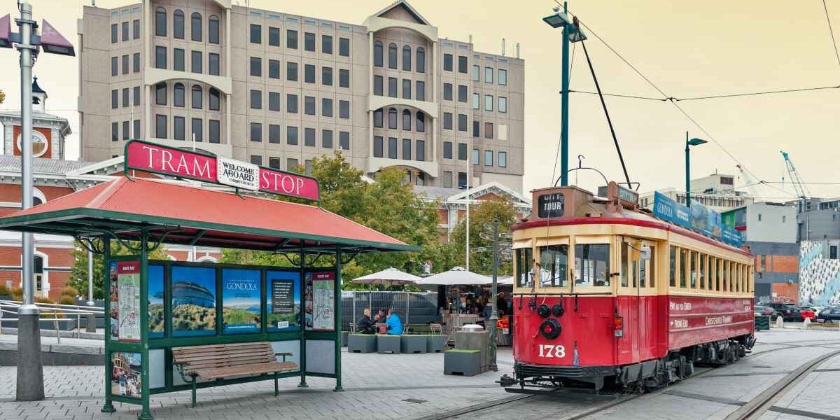 a tram at a stop in Christchurch, where the cost of living in New Zealand is very high